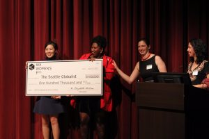 Photo of 2017 Arts & Culture WAWF grantee The Seattle Globalist with big check
