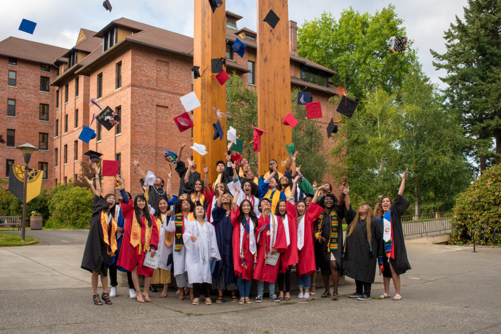 Photo of graduates throwing caps in air; photo from 2020 Education Merit Award winner Palmer Scholars
