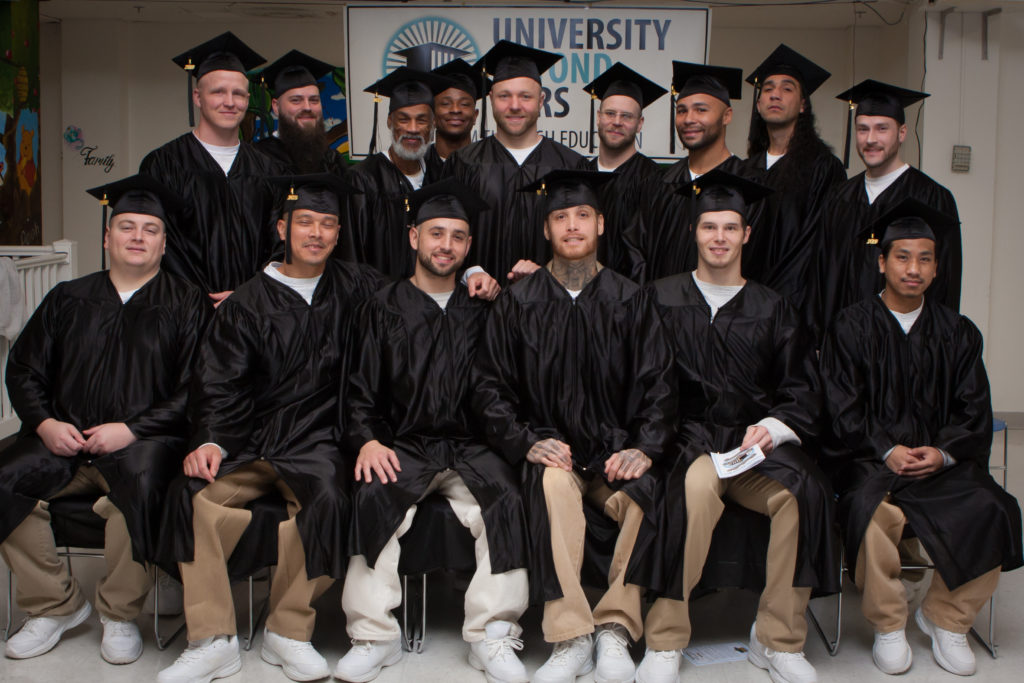 Photo of graduates in cap and gown from 2020 Education grantee University Beyond Bars